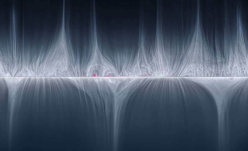 Abstract image featuring fine, vaporous patterns resembling flowing waterfalls interspersed with a horizontal line in the middle. The pattern is illuminated by subtle gradients of light blue and white, creating a serene and ethereal atmosphere. Small pink dots appear scattered along the horizontal line.